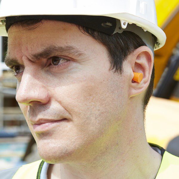 A man wearing a custom earplug